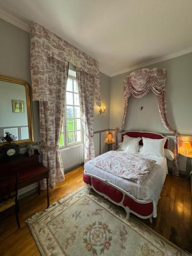 a bedroom with a large bed and a window at Domaine de L'orangerie du château de Motteville chambres d'hotes in Motteville