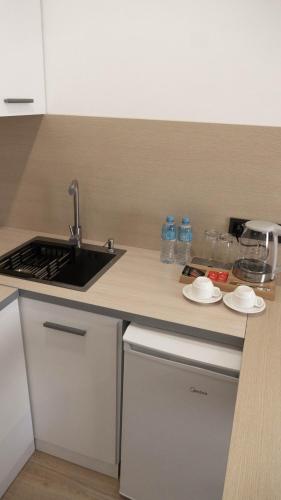 a kitchen with a sink and a counter top at Hide Apart Hotel in Aktau
