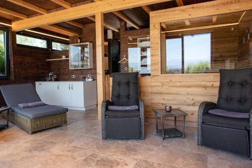 a living room with two chairs and a table at Alpresort Tirol in Reith bei Seefeld