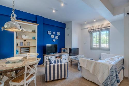 a living room with a blue accent wall at Chroma Pelion Villas in Kato Gatzea