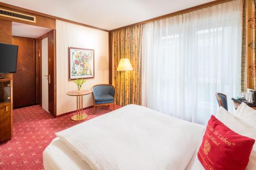 a hotel room with a bed and a window at Best Western Premier Grand Hotel Russischer Hof in Weimar