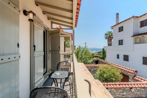 a balcony with two chairs and a table at Chroma Pelion Villas in Kato Gatzea