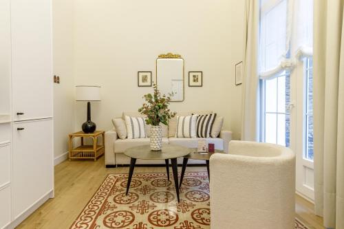 a living room with a couch and a table at Palacio Vegafuente by Caleta Homes in Málaga