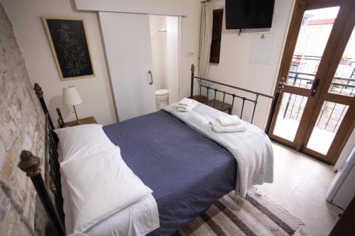 a bedroom with a bed with towels on it at Lazaros Stonehouse in Pano Lefkara
