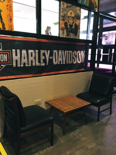 a waiting room with two chairs and a table at Cafe Moto Hostel in Puerto Princesa City