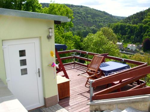 a balcony with two chairs and a door with a view at Haus-Panoramablick in Königstein an der Elbe