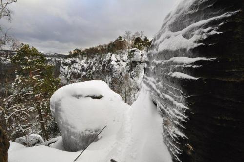 a snow covered rock wall with snow on it at Haus-Panoramablick in Königstein an der Elbe