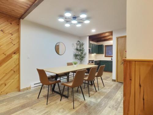 a dining room with a table and chairs at BearHug AC, Pool, Hot Tub, Tennis, Close to Resort in Killington