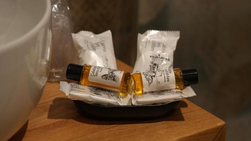 two bottles of toothpaste in a container on a table at Residenza Gurnea - Free Private Parking in Tropea