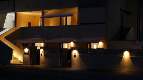 a building with lights on the side of it at night at Residenza Gurnea - Free Private Parking in Tropea
