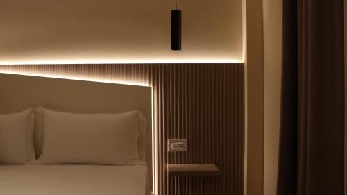 a bedroom with a bed with a light above it at Residenza Gurnea - Free Private Parking in Tropea