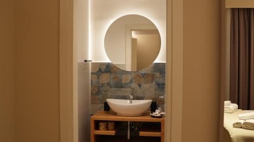 a bathroom with a sink and a mirror on the wall at Residenza Gurnea - Free Private Parking in Tropea