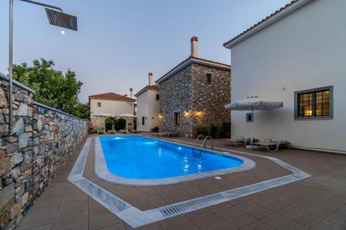 a swimming pool in the backyard of a house at Chroma Pelion Villas in Kato Gatzea