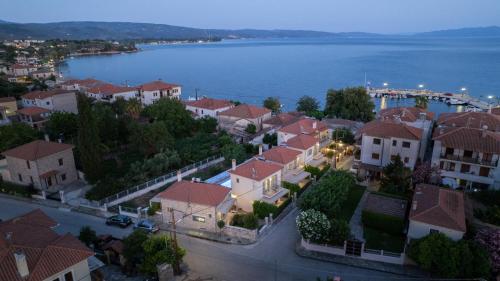 an aerial view of a town next to a body of water at Chroma Pelion Villas in Kato Gatzea