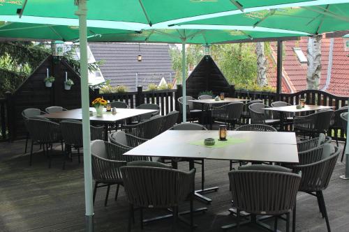 an outdoor restaurant with tables and chairs with umbrellas at Lauenburger Mühle in Lauenburg