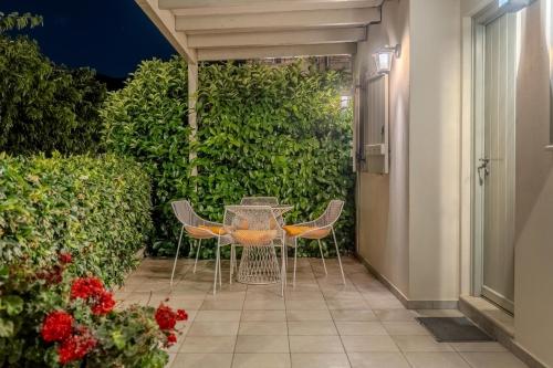 a table and chairs on a patio at night at Chroma Pelion Villas in Kato Gatzea