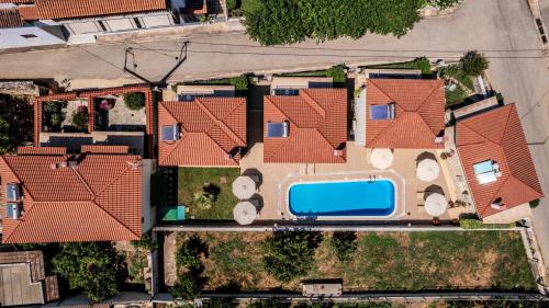 an overhead view of a house with a swimming pool at Chroma Pelion Villas in Kato Gatzea