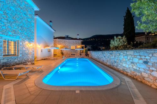 a swimming pool in a villa at night at Chroma Pelion Villas in Kato Gatzea
