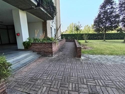 a brick walkway outside of a house with a building at Biri's House in Reggio Emilia