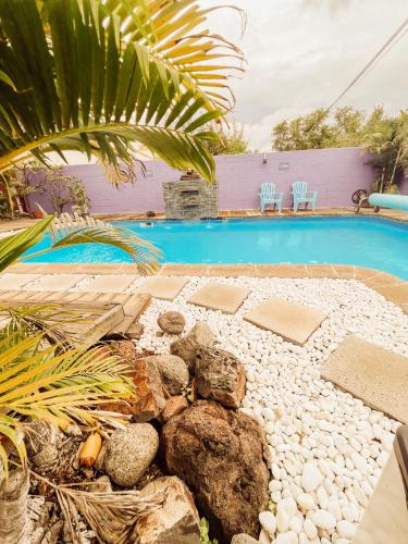 a backyard with a swimming pool and a rock garden at 5 - LE VACOA - CHAMBRE 5 Rdc D in Saint-Paul