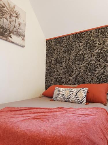 a bedroom with a bed with a large headboard and two pillows at 17 - LE VACOA - CHAMBRE 17 ETG D in Saint-Paul