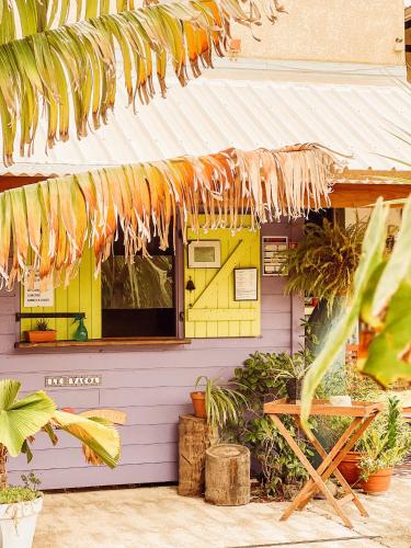 a yellow house with awning and plants in front of it at 17 - LE VACOA - CHAMBRE 17 ETG D in Saint-Paul