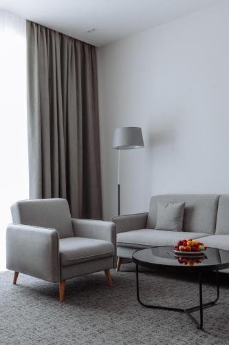 a living room with two couches and a coffee table at Old Ijevan Boutique Hotel in Ijevan