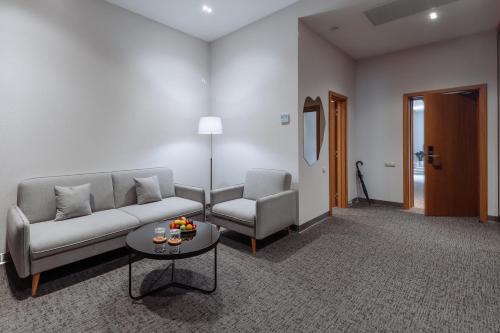 a living room with a couch and two chairs and a table at Old Ijevan Boutique Hotel in Ijevan