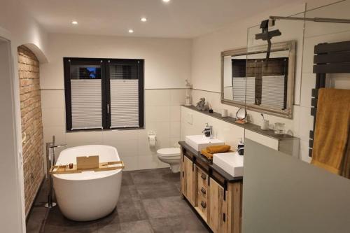 ein Badezimmer mit Badewanne, Toilette und Waschbecken in der Unterkunft Cottbus Merzdorf Bauernhaus Ferienhaus in Cottbus