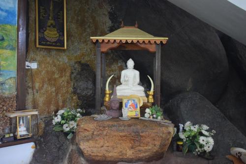 a statue sitting on a table in a room at Namaya Nature in Kandy
