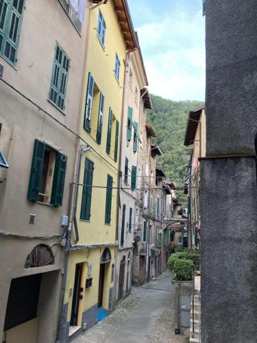 an alley in an old town with buildings at Casa Gaia, La Casa Sui Tetti in Isolabona
