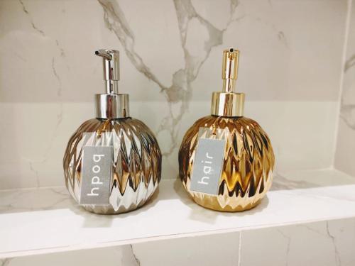 two bottles sitting on a shelf in a bathroom at Villa Emas Mulia Uluwatu Standard 5 in Uluwatu