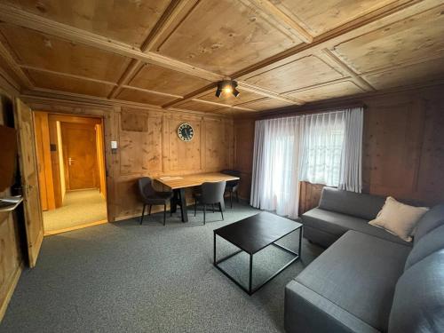 a living room with a couch and a table at Sonne in Klosters