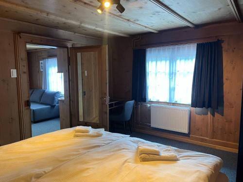 a bedroom with a large bed with two towels on it at Sonne in Klosters