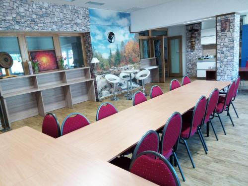 a conference room with wooden tables and chairs at Aparthotel Rezidence Club Canada Lipno in Lipno nad Vltavou