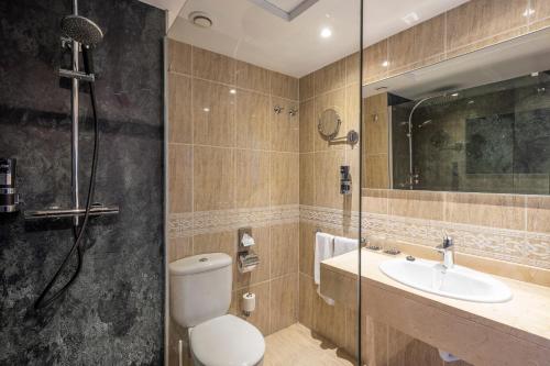 a bathroom with a toilet and a sink and a shower at NYX Hotel Ibiza by Leonardo Hotels-Adults Only in San Antonio Bay