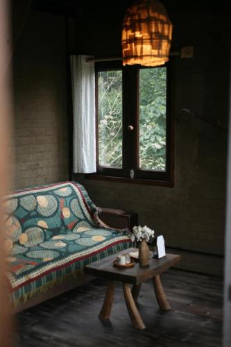 a living room with a couch and a coffee table at Sa Moc - La Maison House & Bungalow in Sa Pa