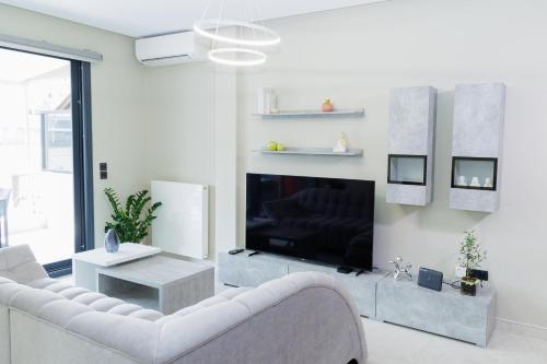 a living room with a white couch and a fireplace at city chic penthouse in Thessaloniki