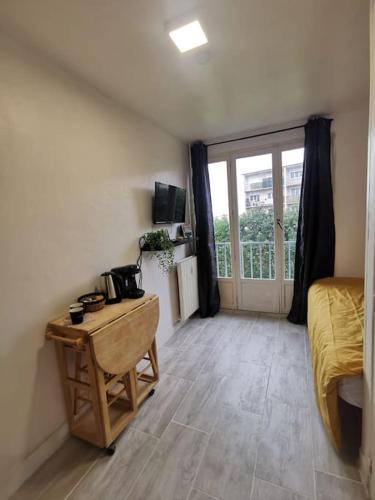 - une chambre avec un bureau, un lit et une fenêtre dans l'établissement L'essentiel, à Évreux