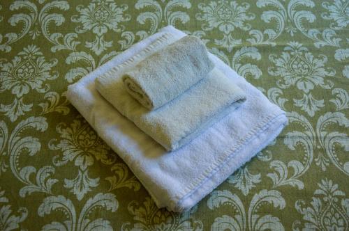a towel is sitting on top of a bed at Agriturismo Picchio Rosso in Forlì