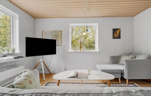a living room with a couch and a tv at Amazing Home In Højby With Wifi in Højby