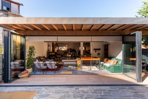 an open patio with a living room and dining room at Feel Discovery P&P House Douro Valley in Resende
