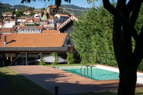 a swimming pool with a view of a city at Feel Discovery P&P House Douro Valley in Resende