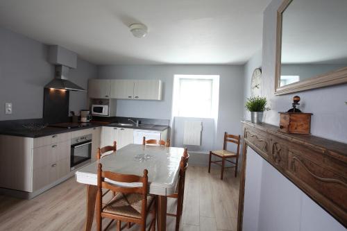 une cuisine avec une table et des chaises dans une pièce dans l'établissement appartement 6 personnes, à Grust