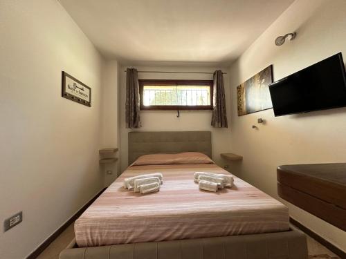 a bedroom with a large bed with two chairs at Inosim - Casa vacanze in Selargius