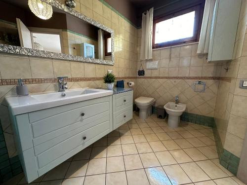 a bathroom with a sink and a toilet at Inosim - Casa vacanze in Selargius