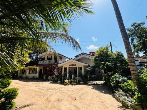 a house with a palm tree in front of it at Villa Eco Green Airport in Katunayake