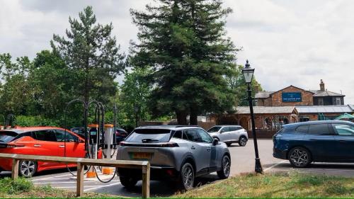 a group of cars parked in a parking lot at The Eaton Oak in Saint Neots