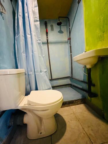 a bathroom with a toilet and a sink at Villa Eco Green Airport in Katunayake