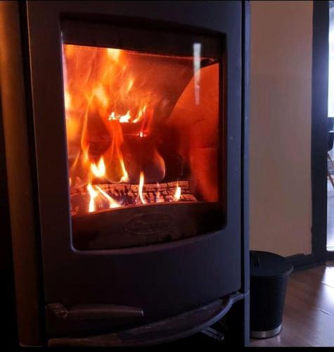 a oven with a fire inside of it at Old Town House in Rjukan
